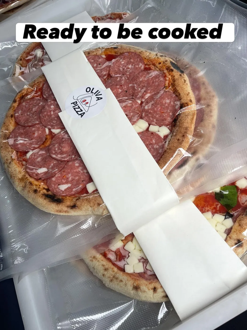 A Bake at Home pizza wrapped and labelled 'Ready to be cooked'