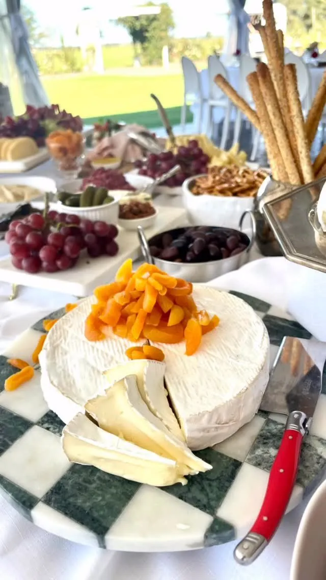 A grazing table close up: olives, cheese, grapes and cured meats