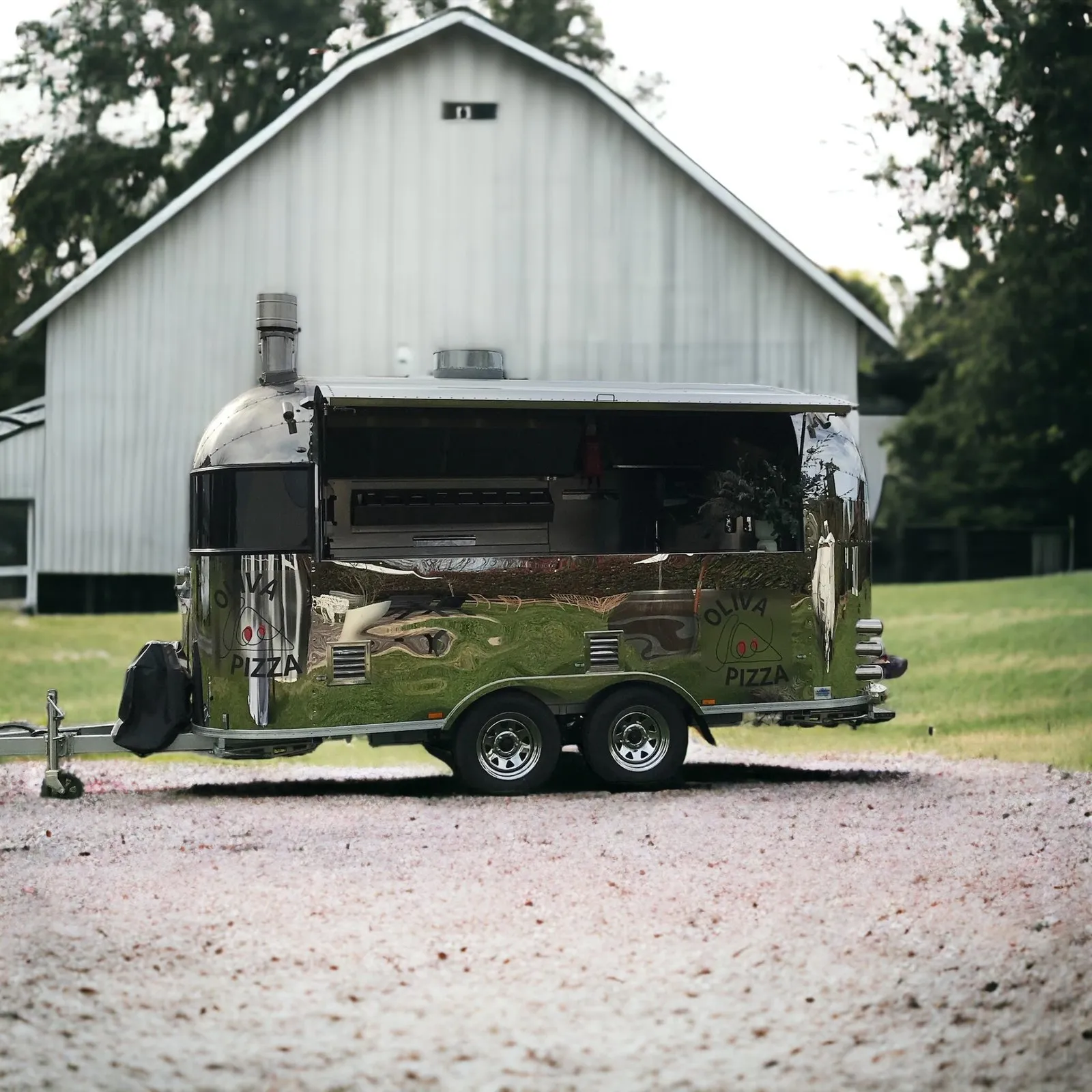 The trailer parked in front of a white timber barn